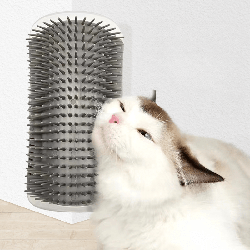 White cat rubbing against a corner-mounted tickling comb self-grooming brush